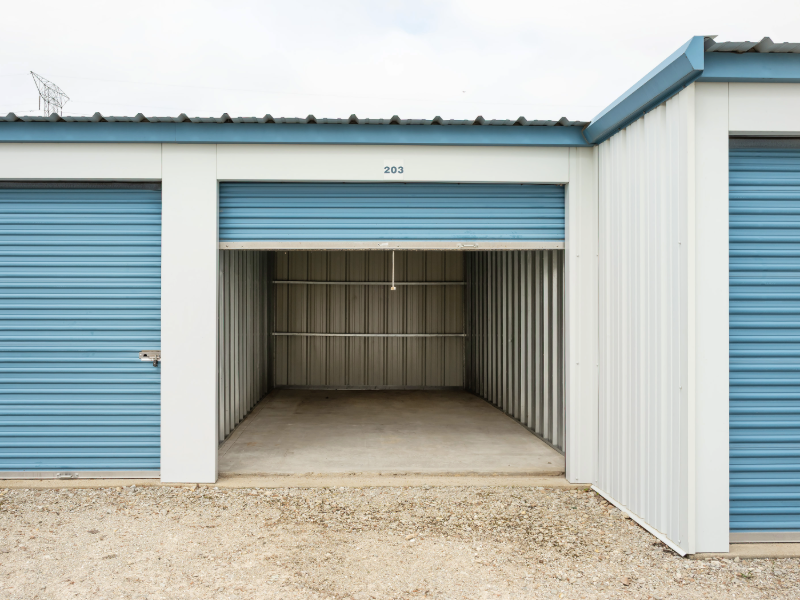 Open drive-up storage unit showing clean concrete floor and lighted interior at All Seasons Storage in Franksville, WI