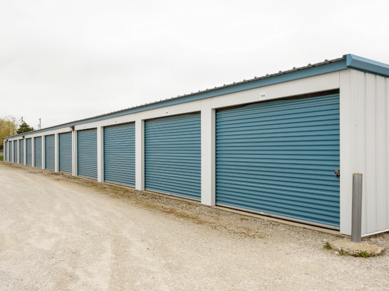 All Seasons Storage unit building with numbered roll-up doors and gravel drive aisle in Franksville, WI